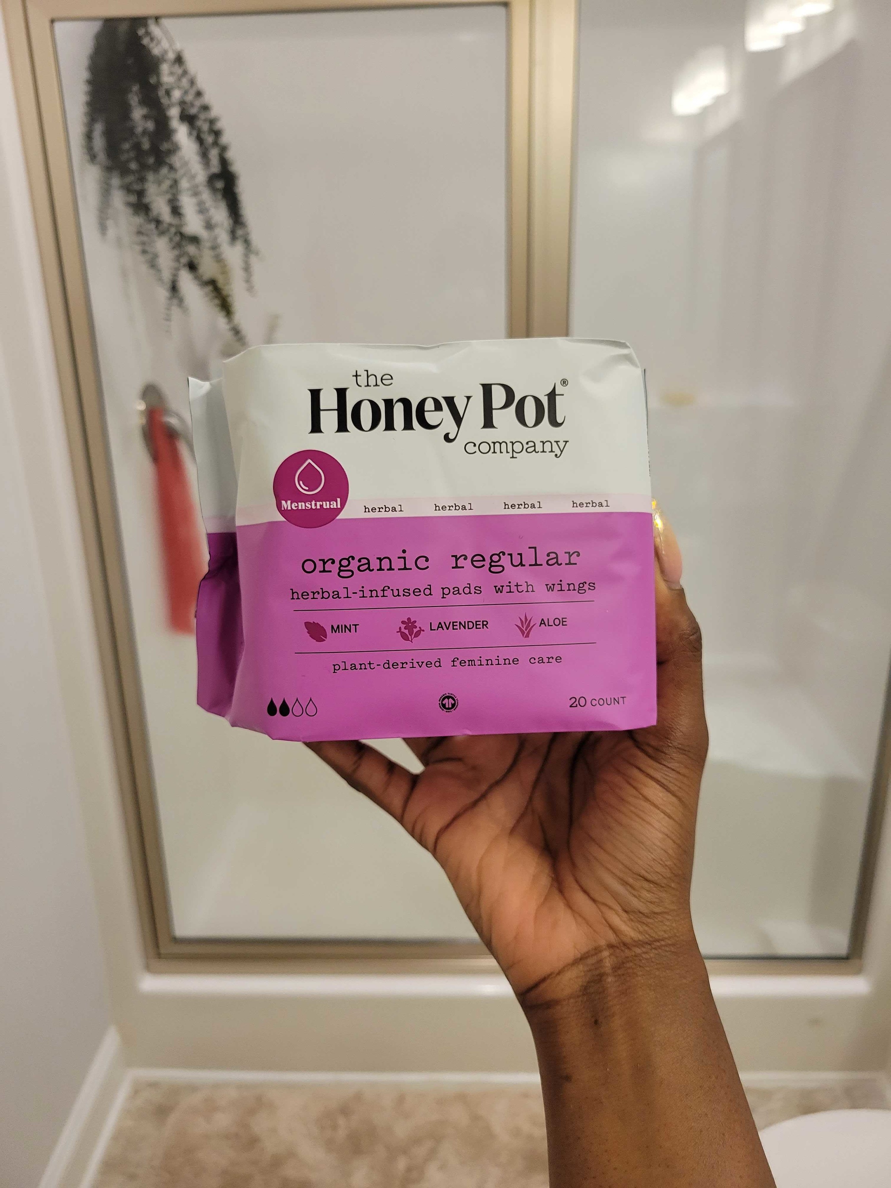 a hand holding a pack pads from The Honey Pot Company