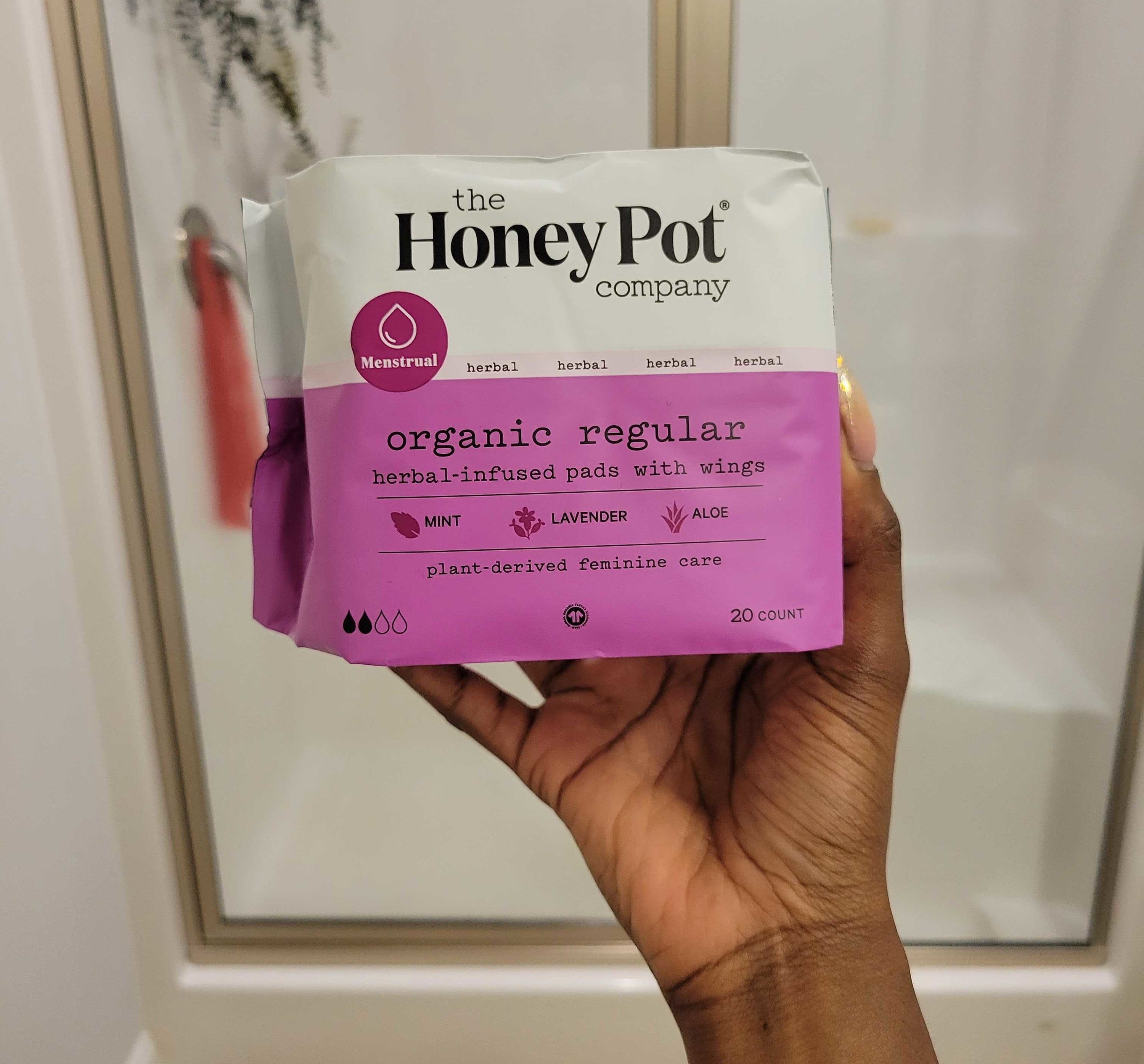 my hand holding a pack pads from The Honey Pot Company