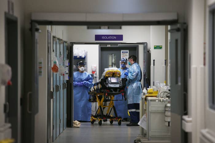 A patient being taken to the isolation ward by healthcare workers