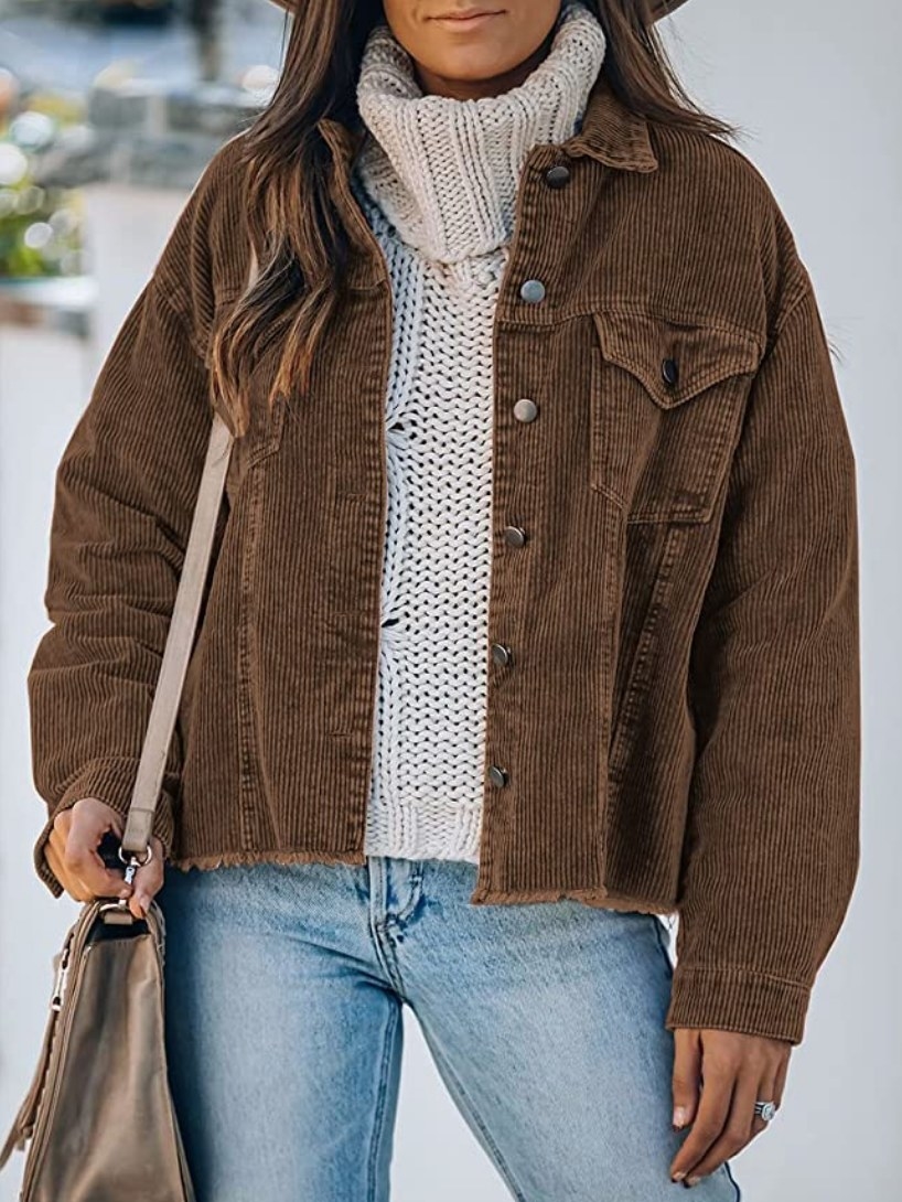 A model wearing a dark brown, long-sleeve, corduroy, button-down jacket