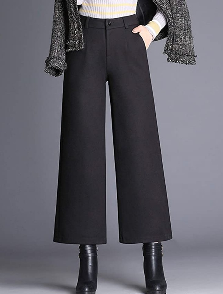 A model wearing a pair of black, high-waisted, wool-blend, cropped, wide-leg trousers
