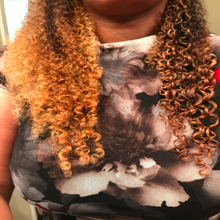 A customer review photo of their hair, half brushed and half not brushed. 