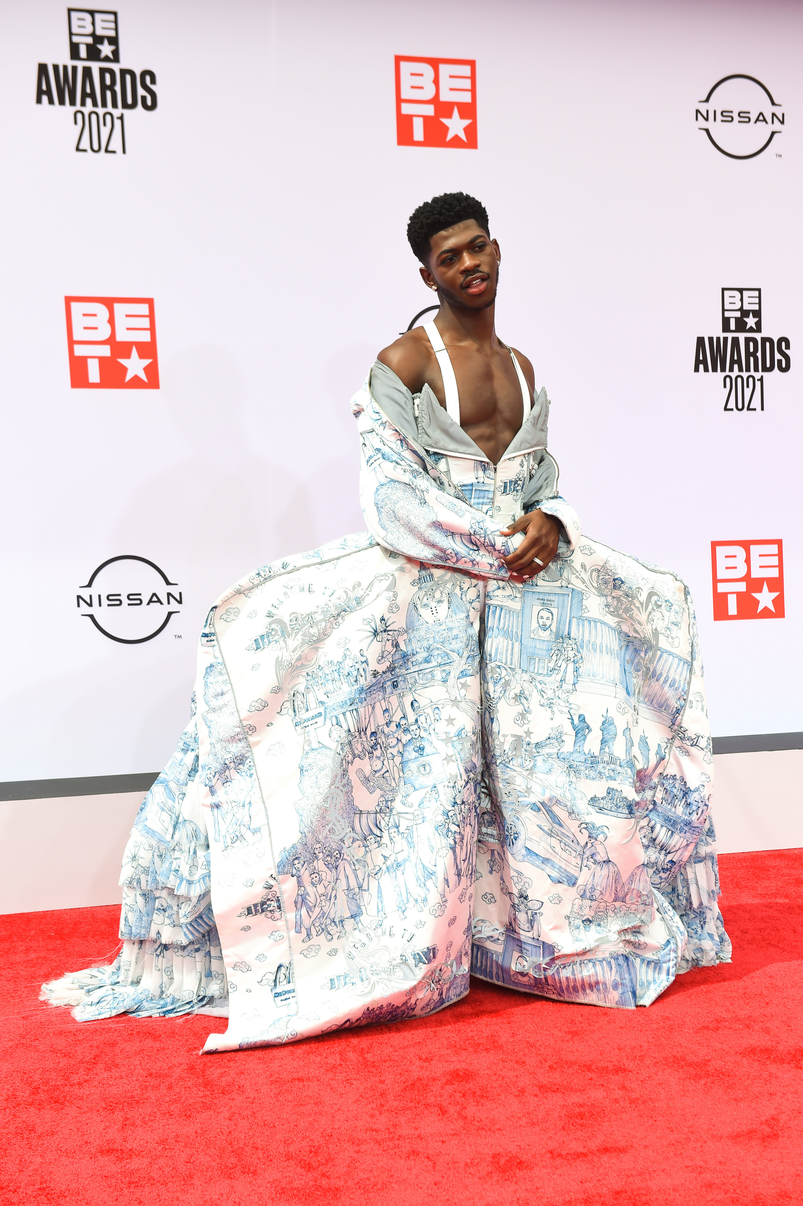 Lil Nas X posing in a voluminous printed gown at the BET Awards