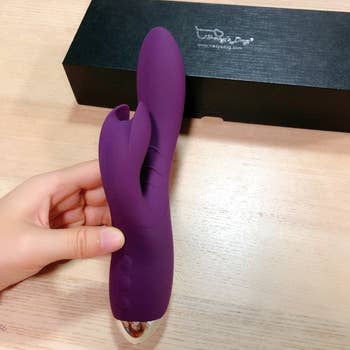 reviewer holding purple rabbit vibrator