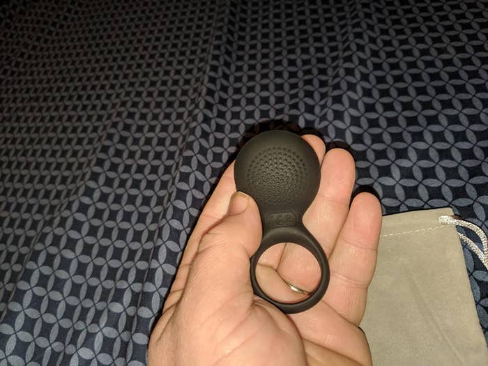 reviewer holding cock ring to display textured bottom