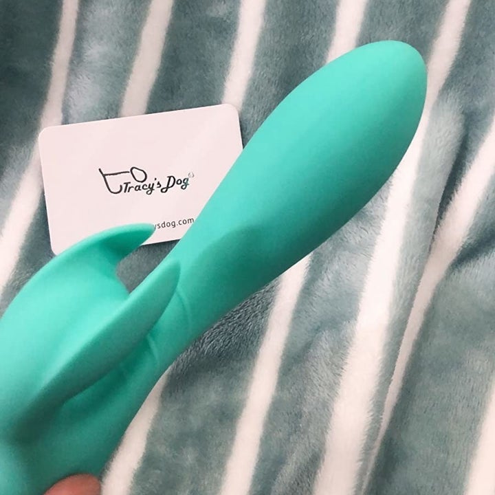 reviewer holding teal rabbit vibrator
