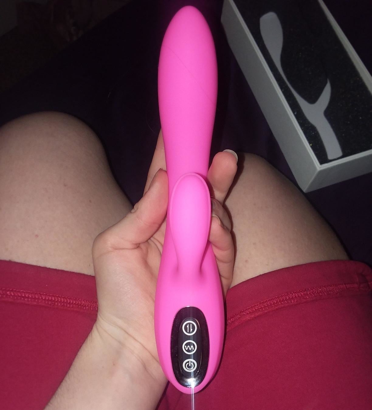 reviewer holding pink rabbit vibrator