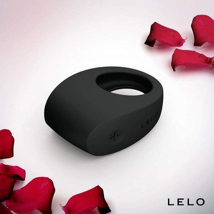 Black cock ring surrounded by rose petals