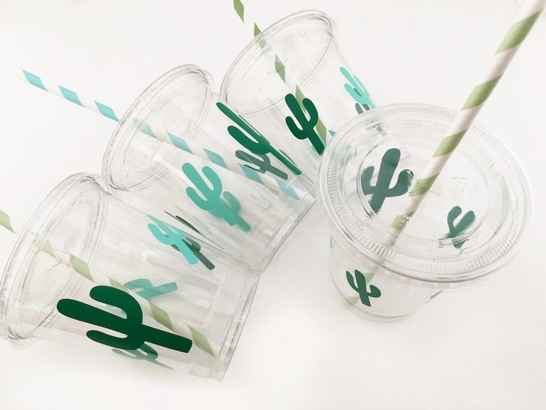 clear cups printed with green cactuses with lids and green and white striped straws