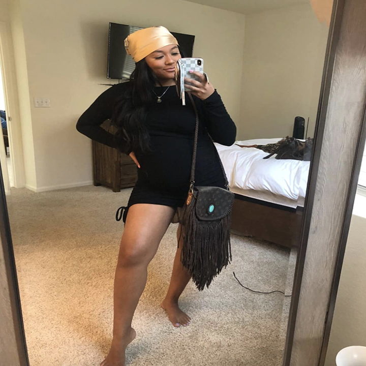 reviewer wearing the black sleeved dress