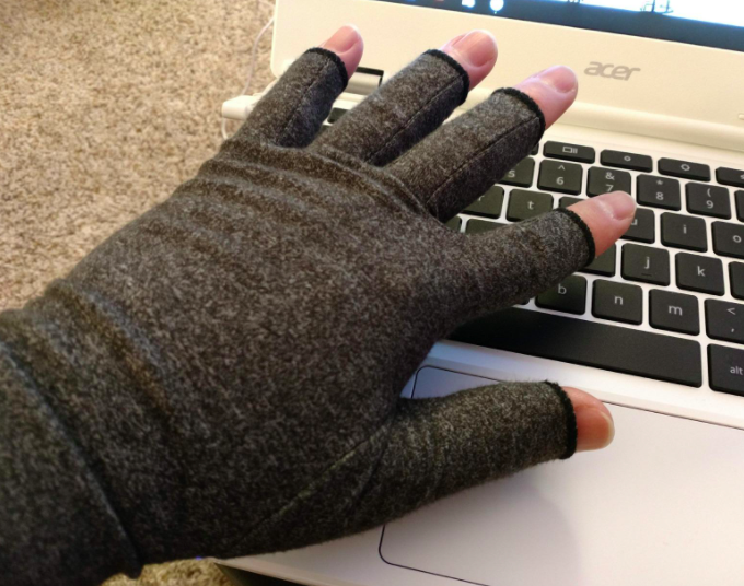 person wearing fingerless glove