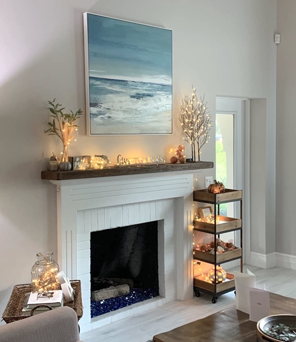 Reviewer&#x27;s fairy lights are placed around a fireplace