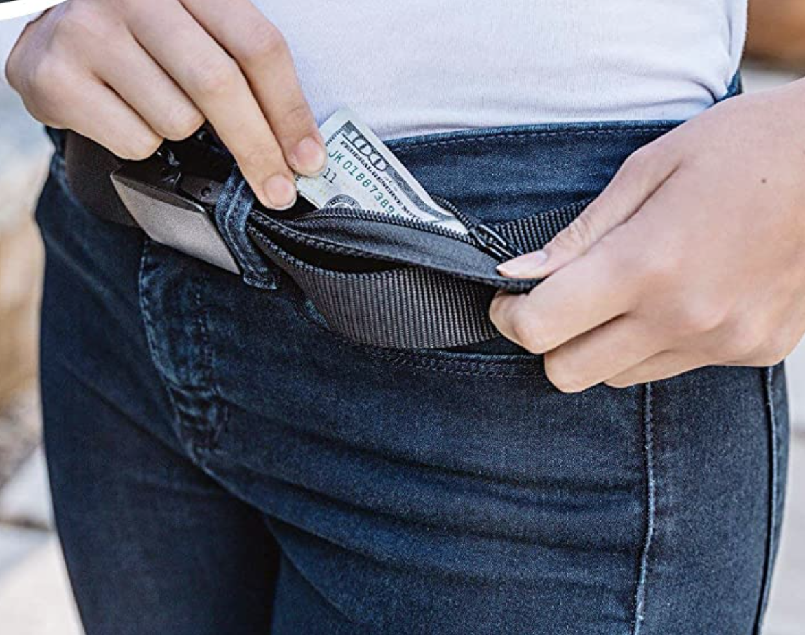 Model pulling cash from hidden pocket of gray belt