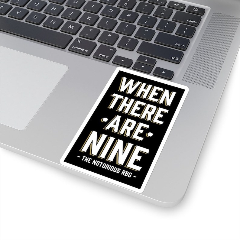 the black and white sticker with the quote and the attribution &quot;the notorious RBG&quot; on a laptop