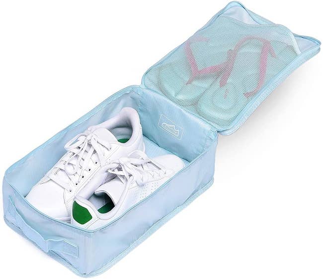 The light blue rectangular shoe bag with a pair of sneakers in the main compartment and sandals in a mesh top one