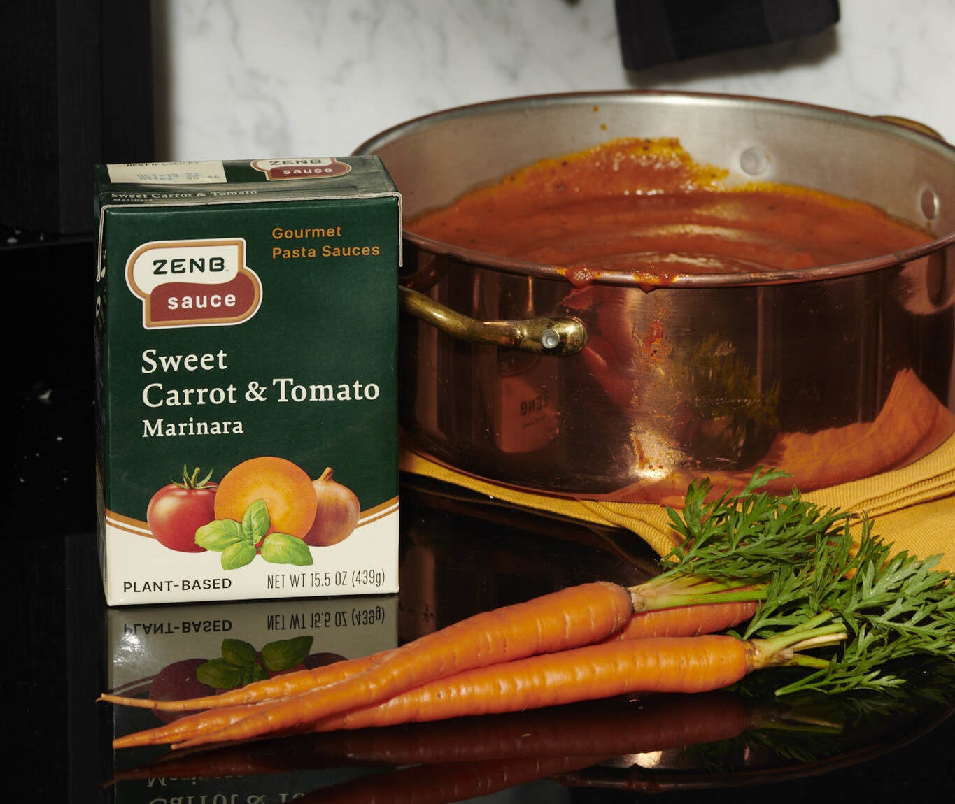 Sweet carrot and tomato marinara sauce near fresh carrots
