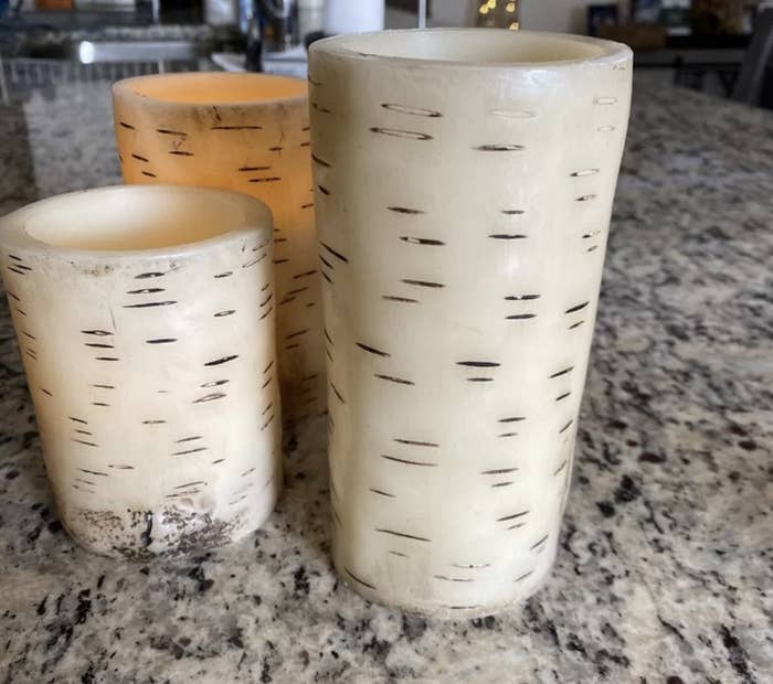 A reviewer photo of a three piece candle set