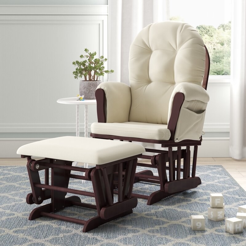 a cream colored glider with a matching ottoman