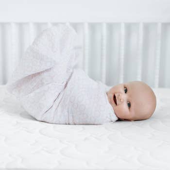 a baby in a halo swaddle