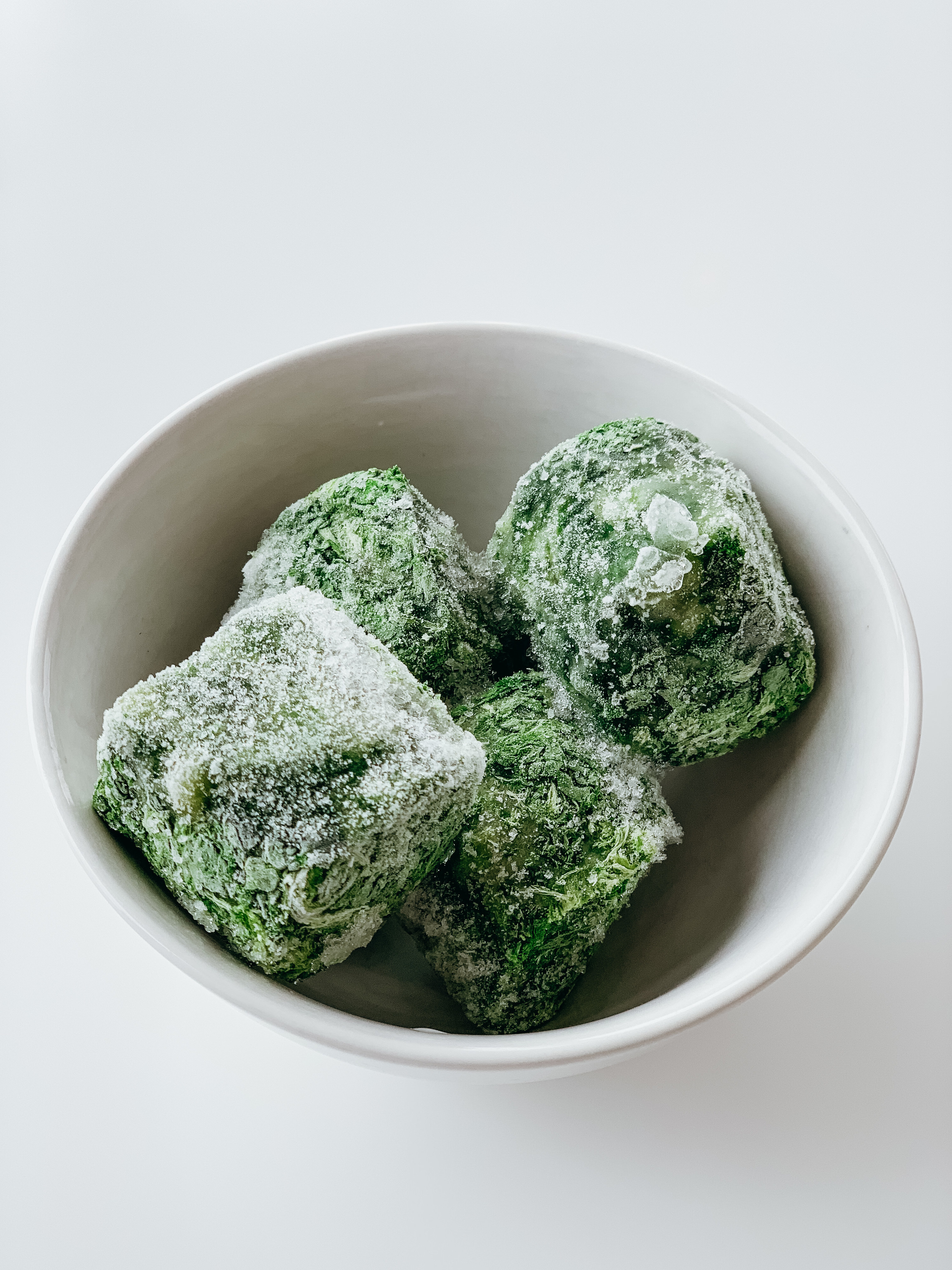 Cubes of frozen spinach in a bowl