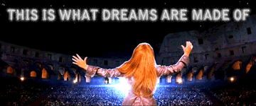 Lizzie McGuire is singing on a stage at the Colosseum in Rome with a message that says, &quot;This is what dreams are made of&quot;