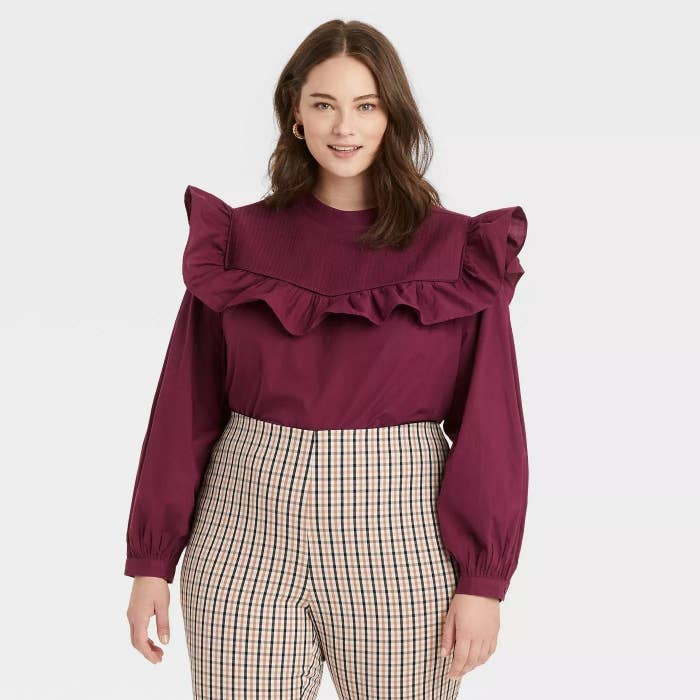 Model wearing burgundy blouse