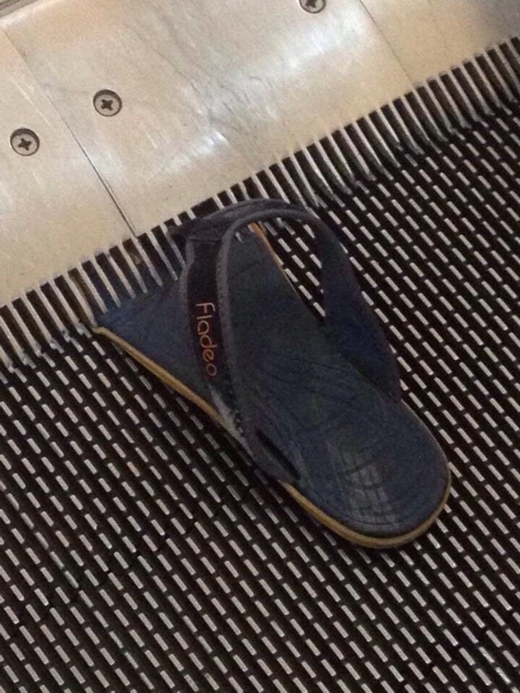 a flip flop sucked into an escalator