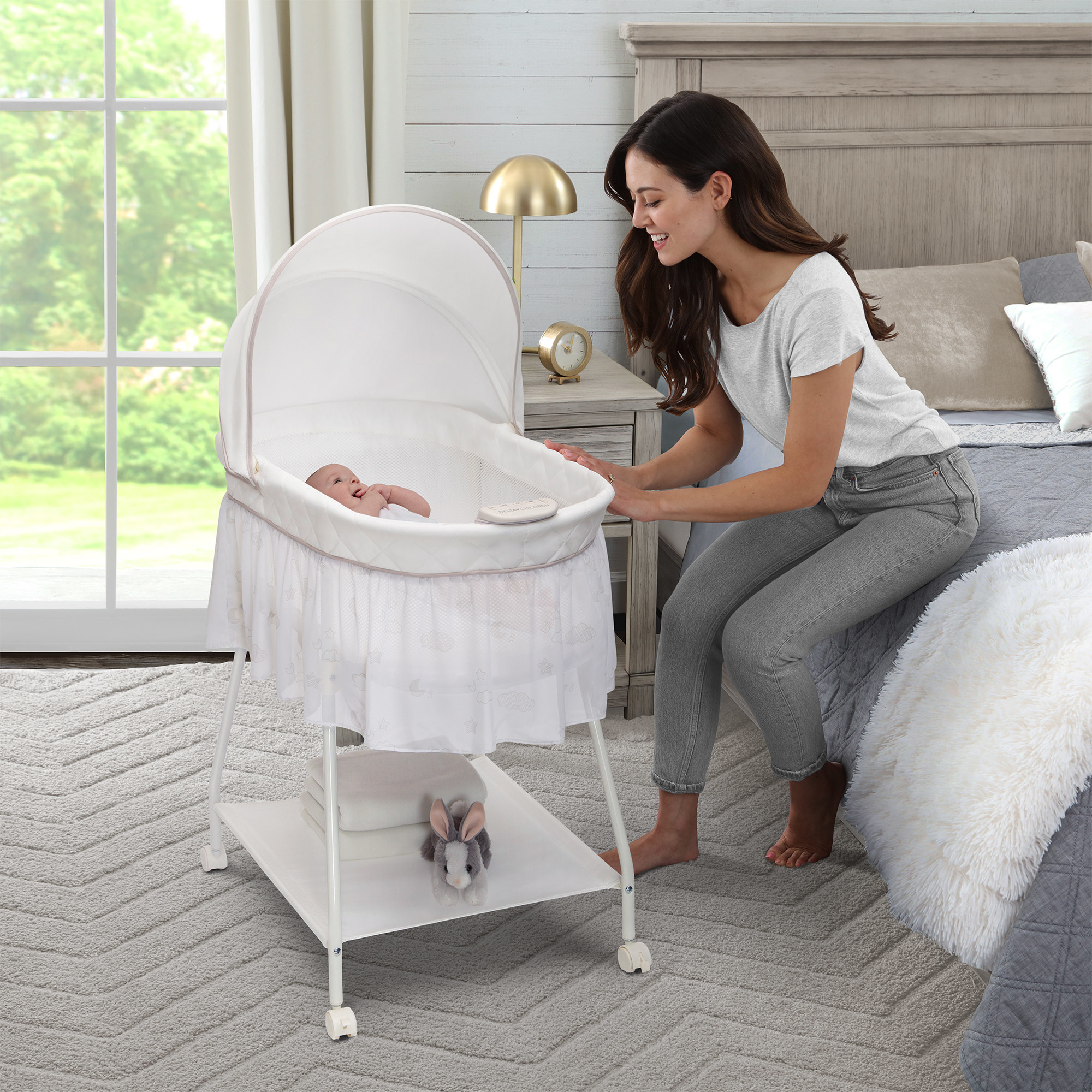 a baby in the white bassinet on wheels