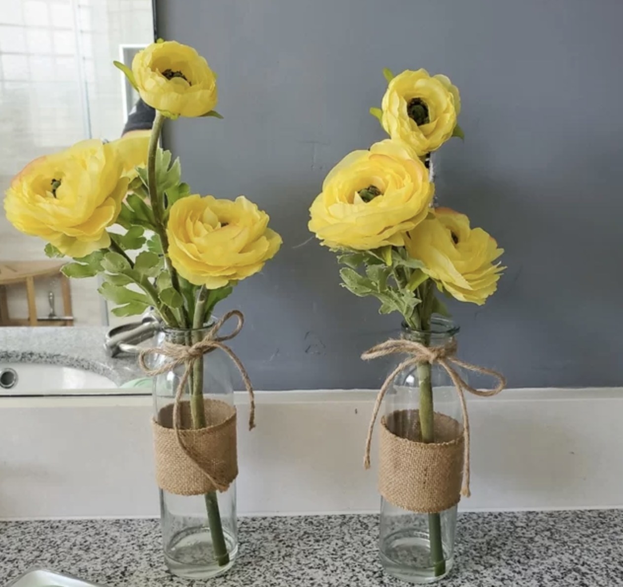 A reviewer photo of faux floral arrangements in vases