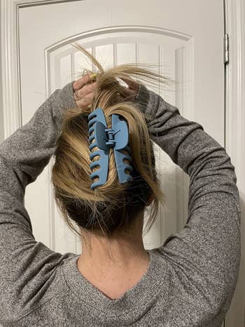 reviewer photo of a blue claw clip holding up their hair
