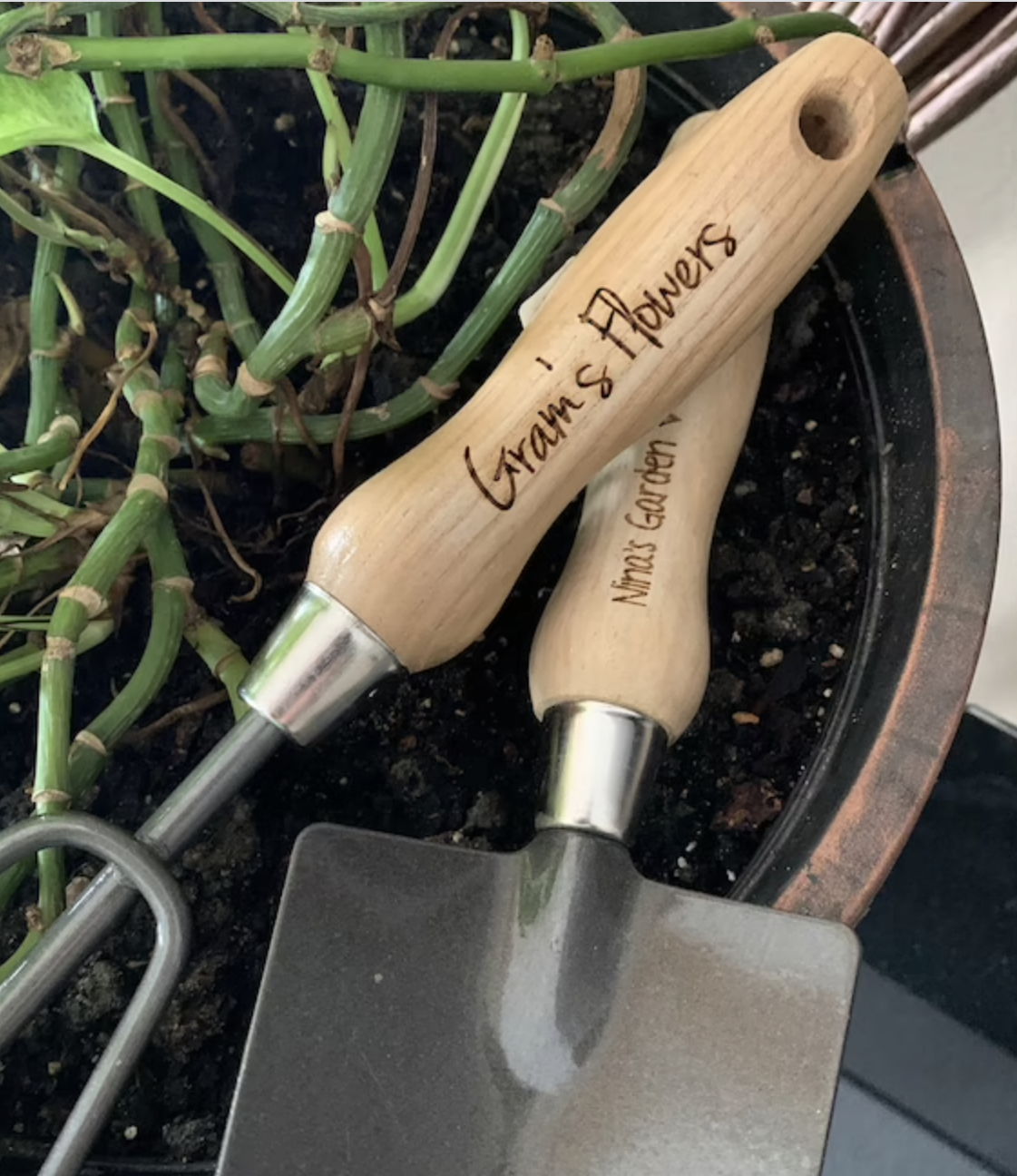 The tools are shown with the handle engraved with Gram's Flowers