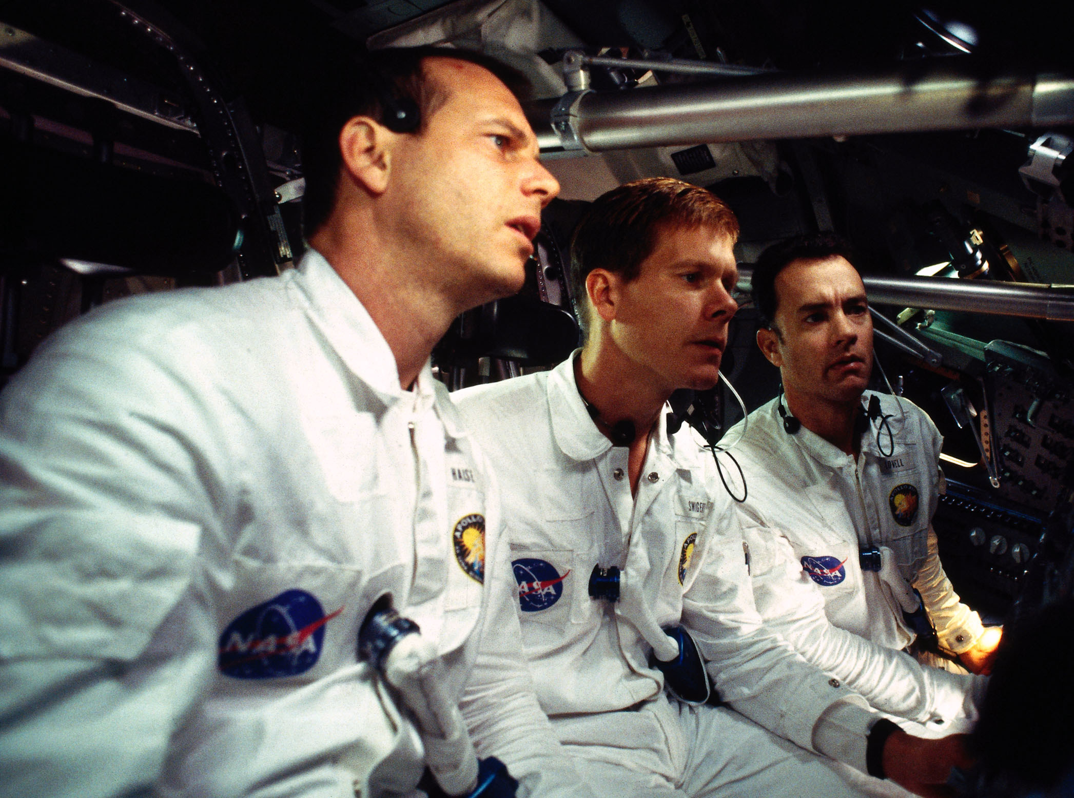 Fred Haise, Jack Swigert, and Jim Lovell wearing their NASA uniforms in the space shuttle