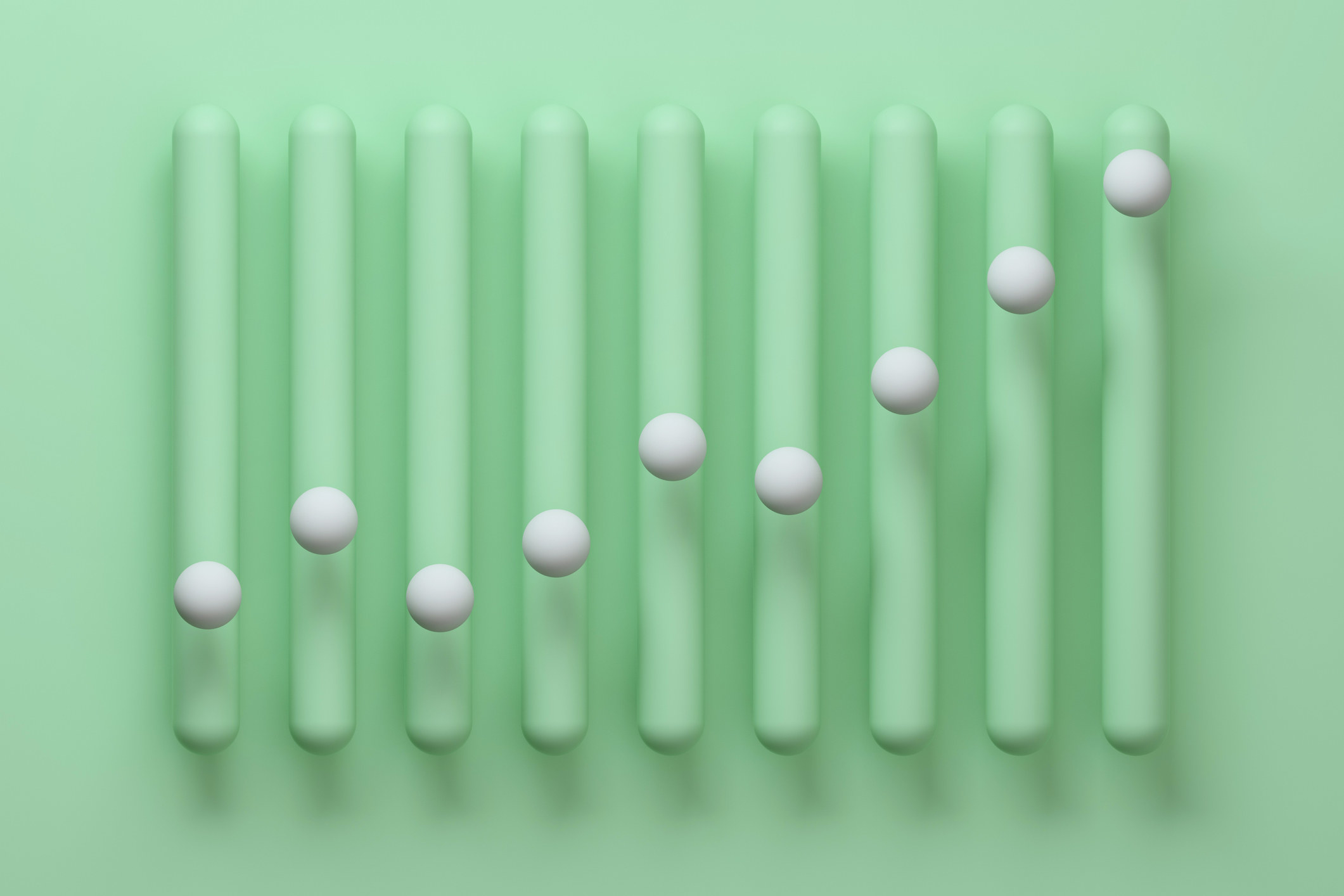 Abstract vertical bar chart made from smooth, round green vertical bars with white spheres