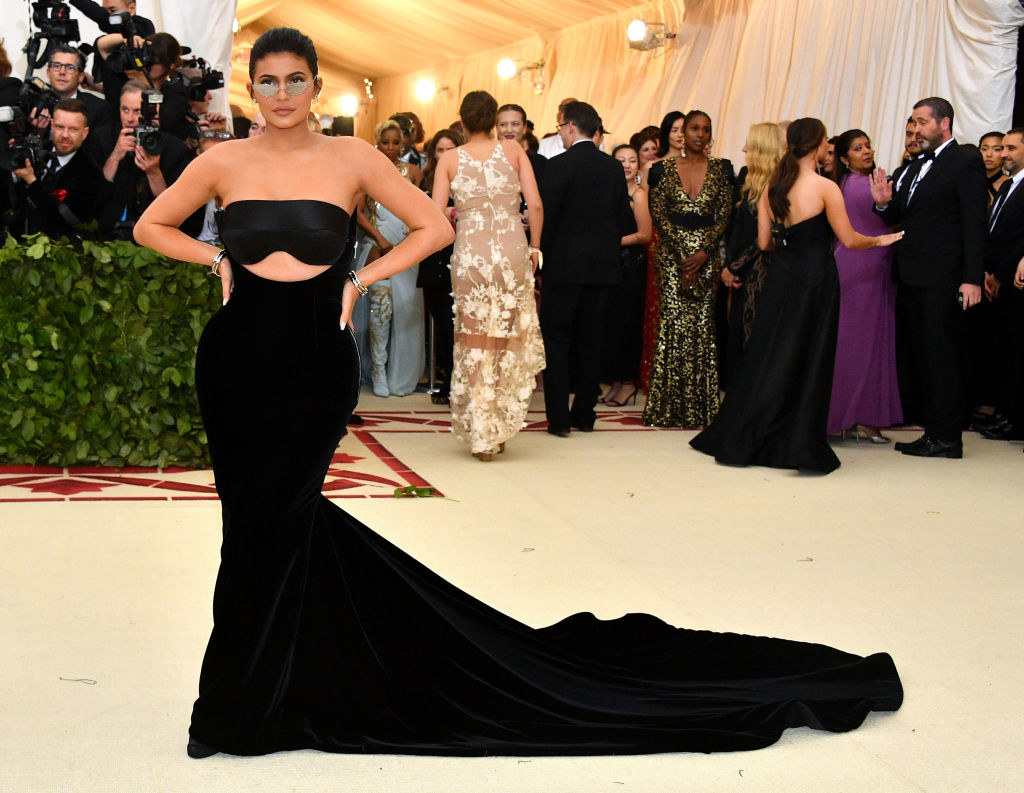 Kylie Jenner attends the Heavenly Bodies: Fashion &amp;amp; The Catholic Imagination Costume Institute Gala in a strapless, floor-length dress and sunglasses