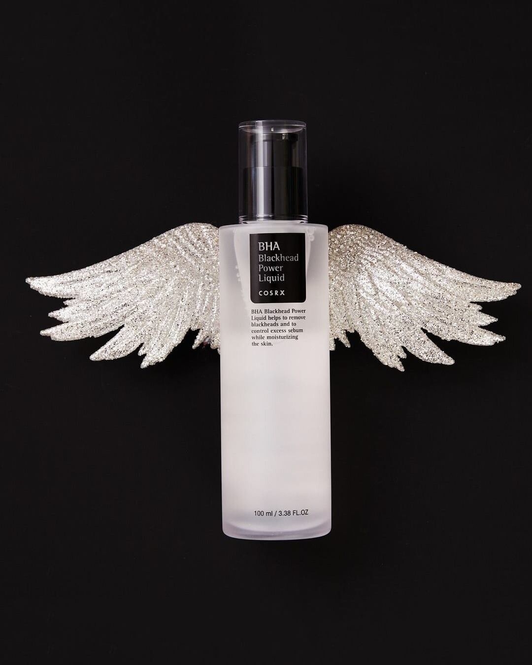 the bottle with angel wings graphic behind it