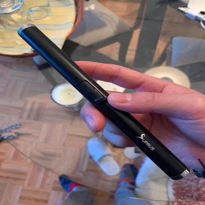 hand holds the black rechargeable lighter