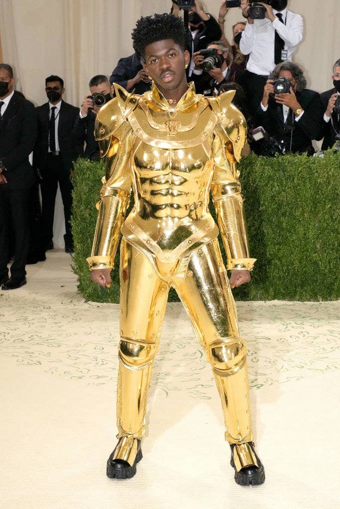 Lil Nas X wears a robotic gold plated suit of armor at the Met Gala