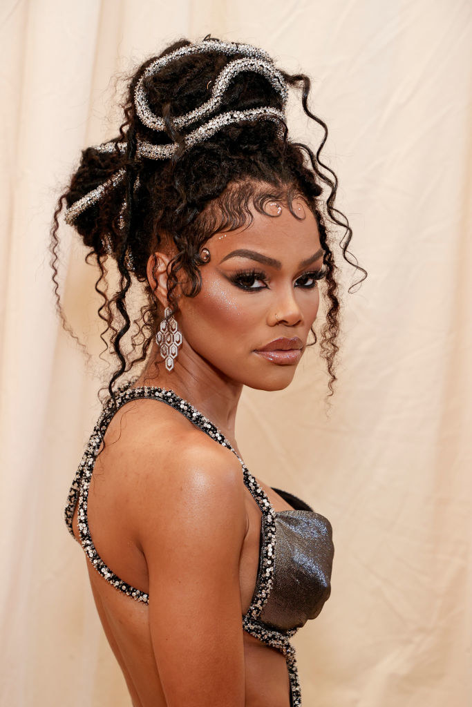 A close up of Teyana Taylor as she shows off her dark eye makeup and dreadlocks