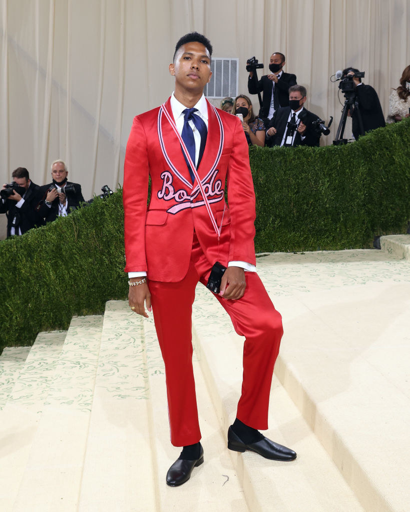 Tyler Mitchell wears a brightly colored suit with the word "Borde" embroidered on the blazer