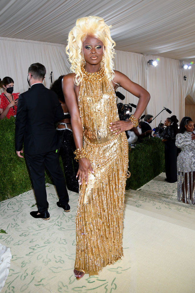Symone wears a high neck sleeveless sparkly fringe gown