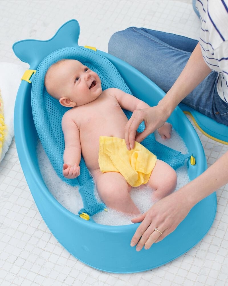 a baby in a whale-shaped tub