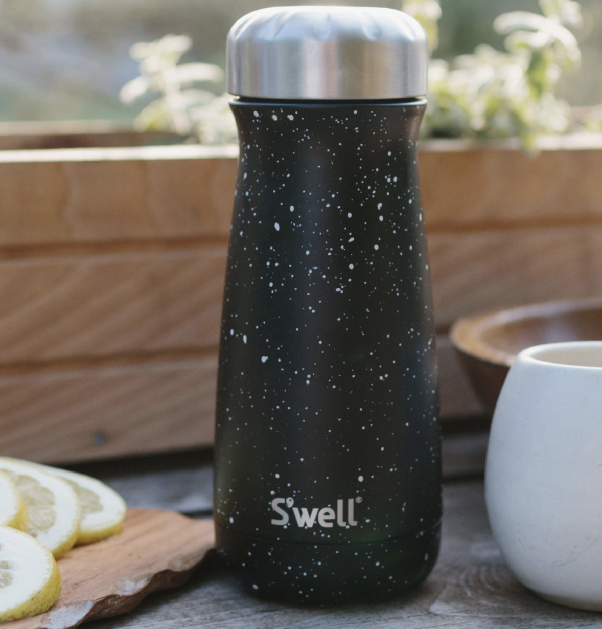 A black matte white speckled S&#x27;well bottle with a twist off metal cap