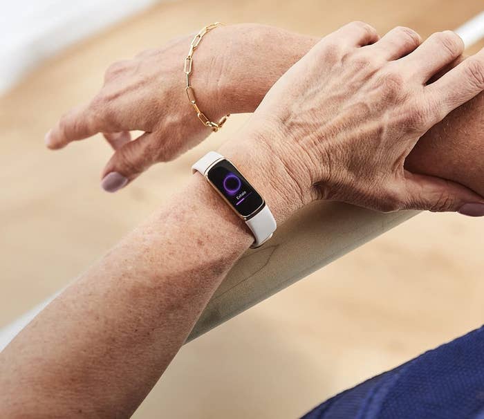 A person wearing the fitness tracker on their left arm