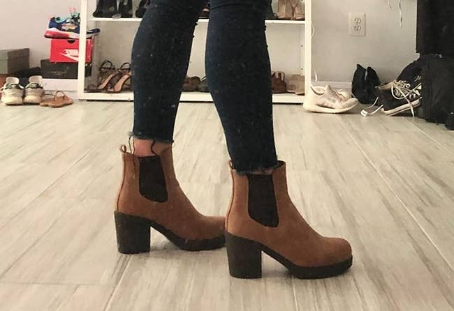 a reviewer wearing the boots in brown 
