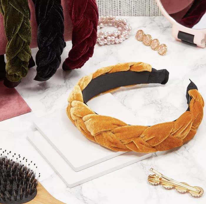 The mustard yellow braided headband on a table