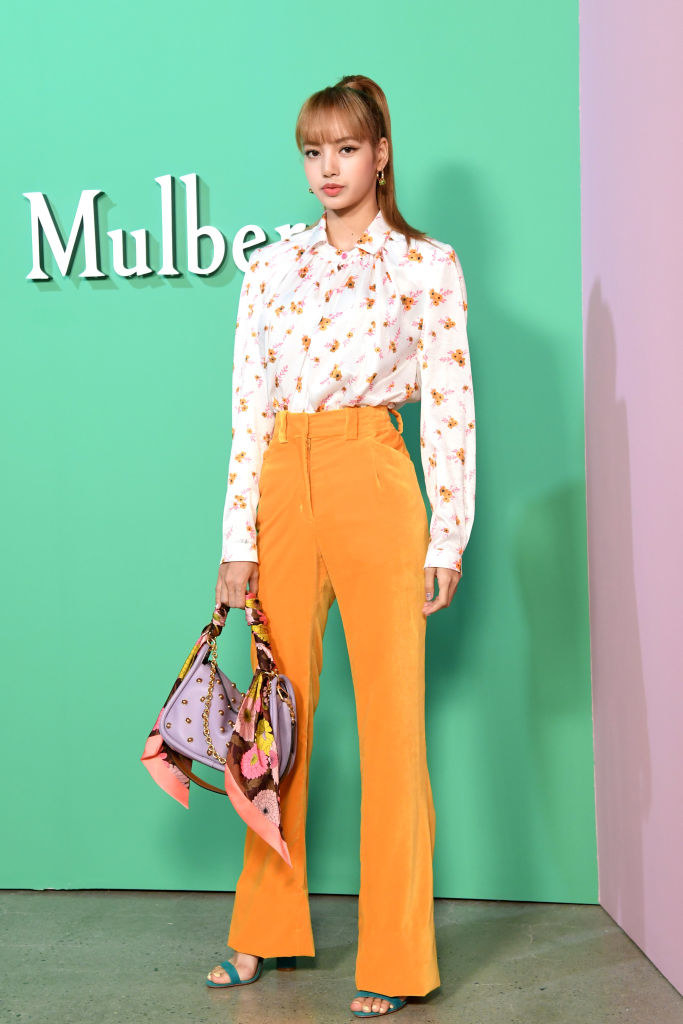 high waisted pants and a floral blouse