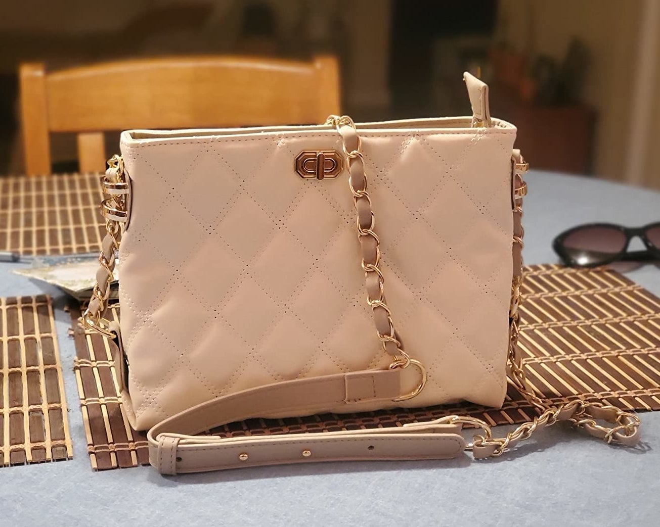 Reviewer photo of the tufted leather bag in a cream color
