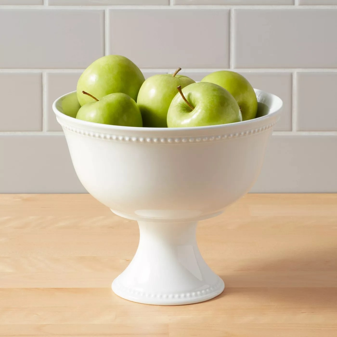 The bowl with apples in it on a kitchen counter
