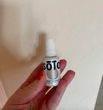 A customer review photo of them holding the paint next to the wall it was just used on
