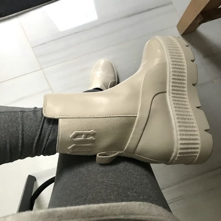 a reviewer wearing the sneaker boots in white
